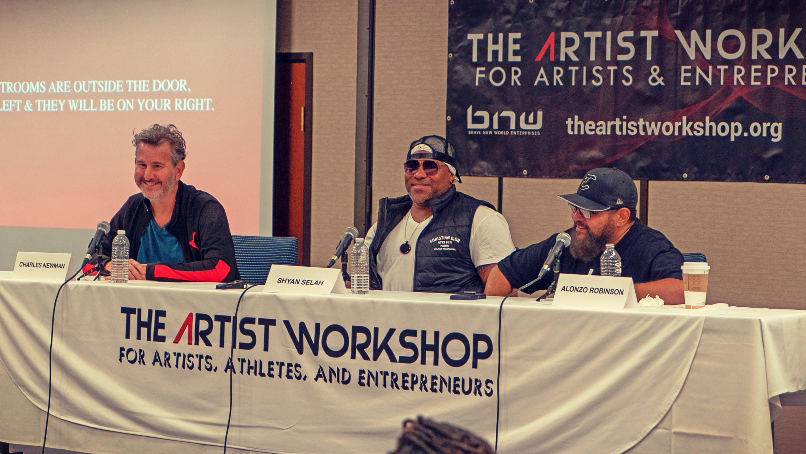 Panelists Charles Newman, Shyan Selah and Alonzo Robinson laugh together at The Artist Workshop: The Long Money Game.