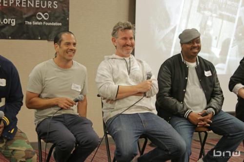 Panelists John Silva, Charles Newman and Kirkland Morris laugh together while listening to a workshop member at The Artist Workshop: Career Day