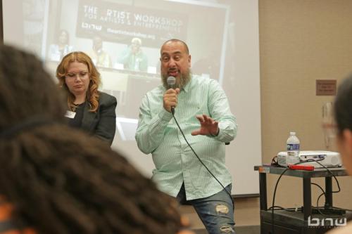 Panelist Jon Stockton responds to a workshop member next to Harriet Duncan at The Artist Workshop: Career Day