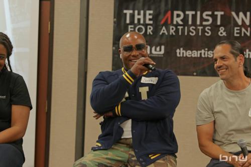 Panelist Shyan Selah speaks to the audience next to John Silva at The Artist Workshop: Career Day