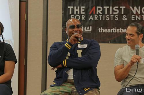 Panelist Shyan Selah responds to the audience next to John Silva at The Artist Workshop: Career Day