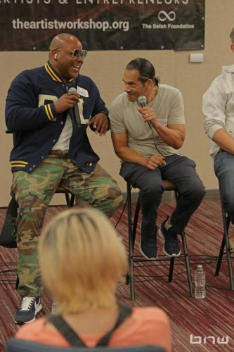 Panelists Shyan Selah and John Silva laugh together at The Artist Workshop: Career Day