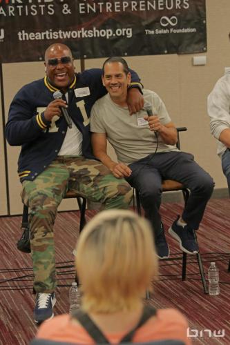 Panelists Shyan Selah and John Silva laugh together at The Artist Workshop: Career Day