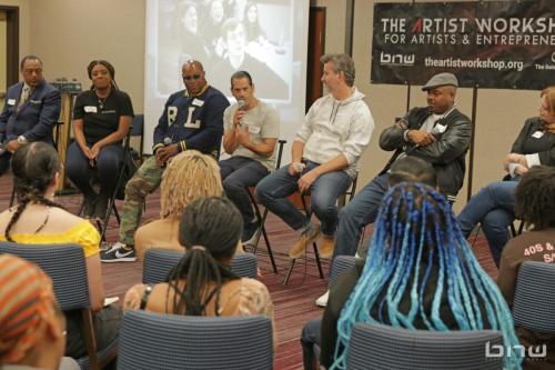 Panelist John Silva answers a workshop member's question next to Curtis Elerson, A'Noelle Jackson, Shyan Selah, Charles Newman, Kirkland Morris and Harriet Duncan at The Artist Workshop: Career Day
