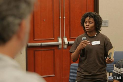 Workshop member Deanna asks a question to the panelists at The Artist Workshop: Career Day