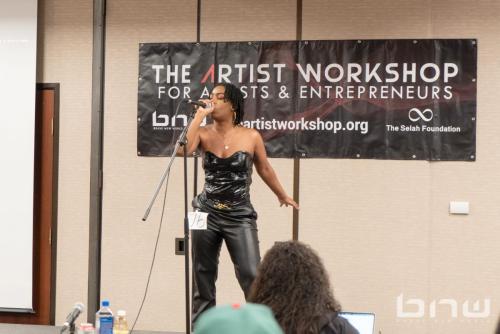A workshop attendee auditions with an original song at The Artist Workshop: Auditions Round One.