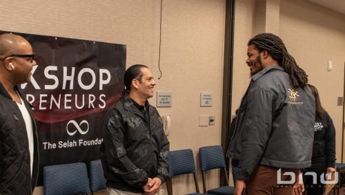Early attendees greet panelist John Silva at the Artist Workshop: The Creative Process 