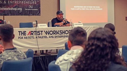 Panelist Alonzo Robinson addresses the room of attendees at The Artist Workshop: The Long Money Game.
