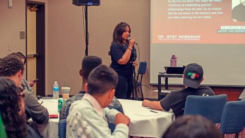 Event Producer Candice Richardson speaks to the group of attendees at The Artist Workshop: The Long Money Game.