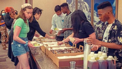 Artist workshop member and staff serving up lunch provided by Panera at The Artist Workshop: The Long Money Game.