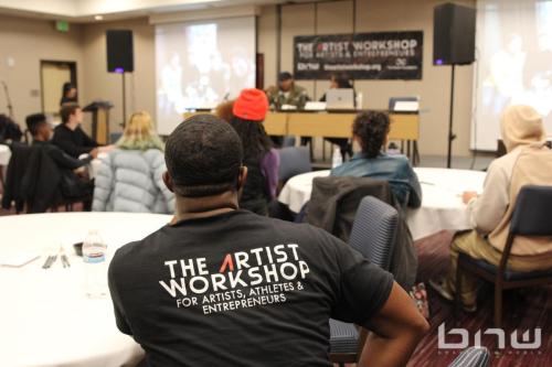 An Artist Workshop staffer wears an event T-shirt at The Artist Workshop: Production 101