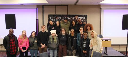 Panelists and attendees pose for a group picture at The Artist Workshop: Production 101 