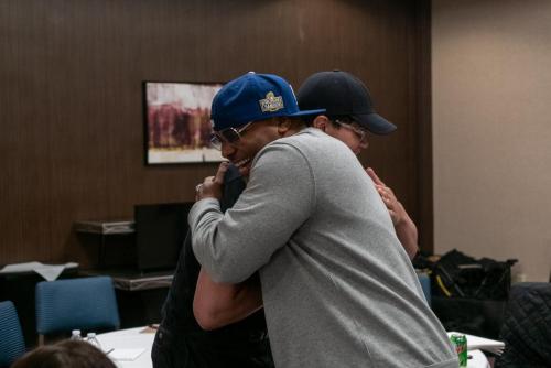 Founder Shyan Selah hugs an attendee at The Artist Workshop: Making the Deal.