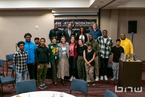 Panelists pose with attendees at The Artist Workshop: Music and Entertainment 101